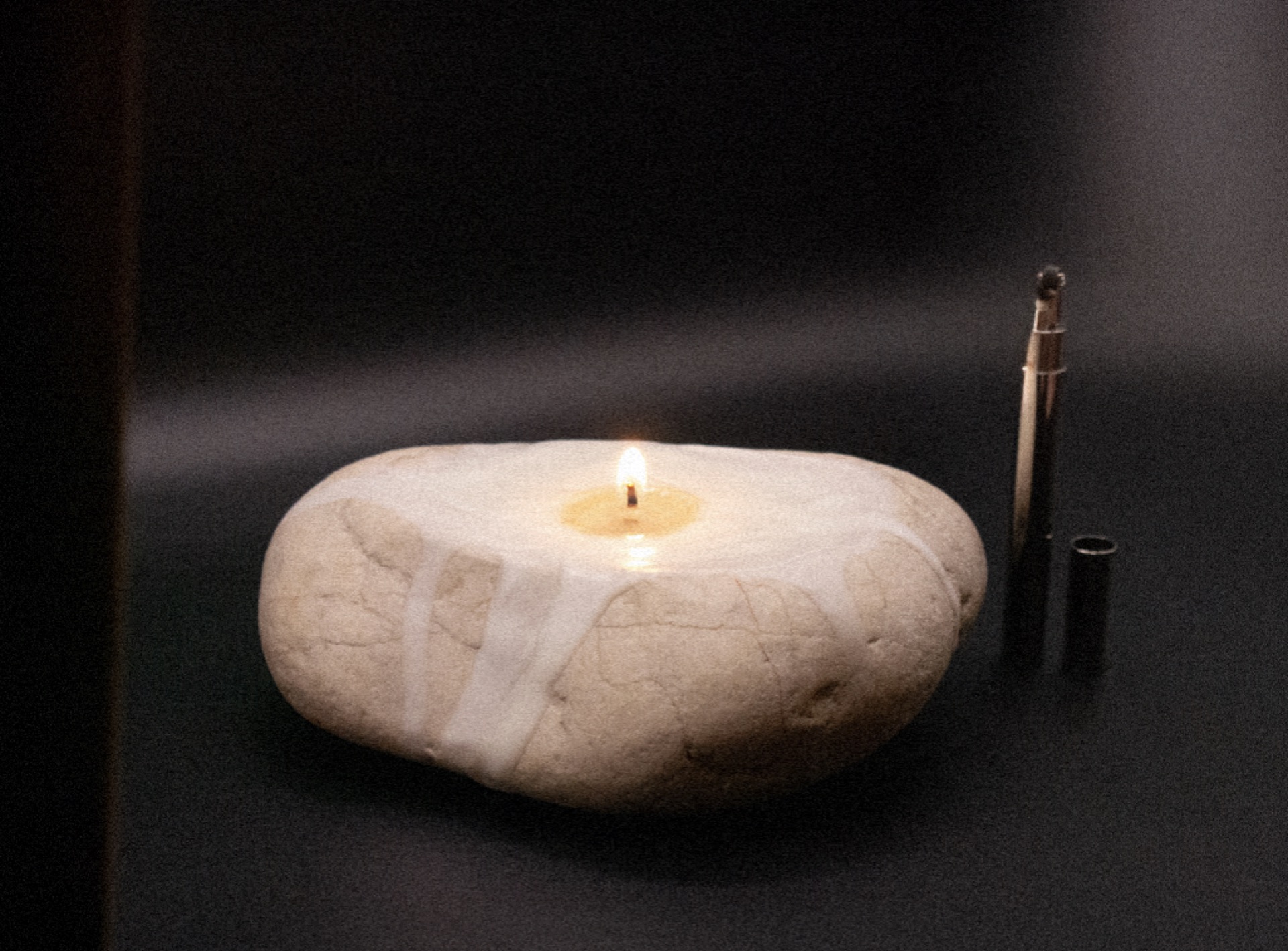 Light as a Rock is a sculptural candle object: carved river rock with custom earthy fragrance, paired with a TSUBOTA sigaretta lighter. Hand-finished, available by request.